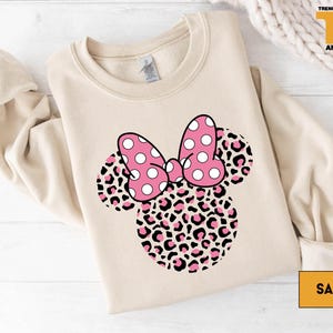 a minnie mouse shirt with a pink bow on it