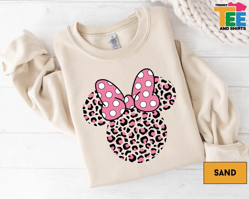 a minnie mouse shirt with a pink bow on it