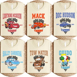 a set of four personalized bibs with cars on them