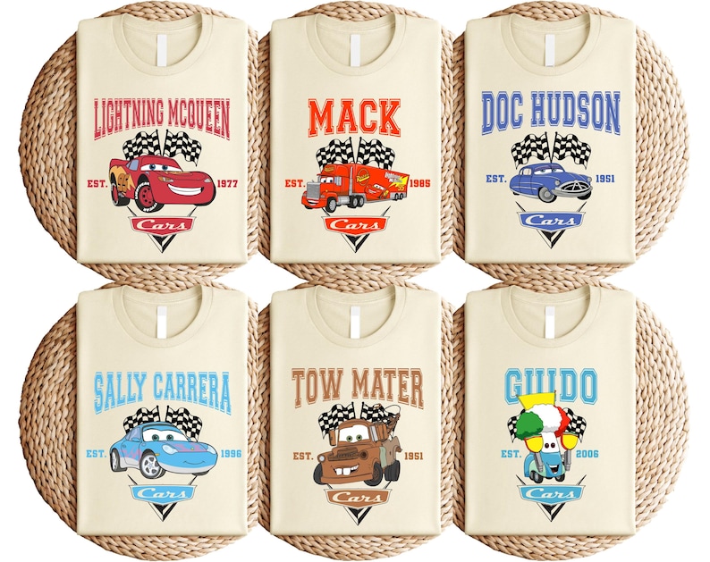 a set of four personalized bibs with cars on them