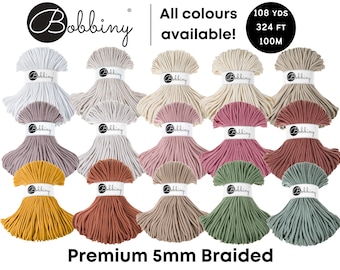 May include: A variety of 18 colors of 5mm braided cotton rope, each in a separate bundle. The rope is 108 yards (324 feet) long and is available in a variety of colors, including white, beige, gray, pink, red, green, and yellow. The rope is labeled "Bobbiny Premium 5mm Braided".
