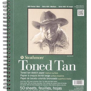 May include: A green spiral-bound Strathmore Toned Tan sketchbook. The cover features a pencil drawing of a person wearing a cowboy hat. The sketchbook contains 50 sheets of acid-free, toned tan sketch paper, measuring 9 x 12 inches.