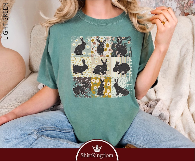 a woman sitting on a couch wearing a t - shirt with rabbits on it