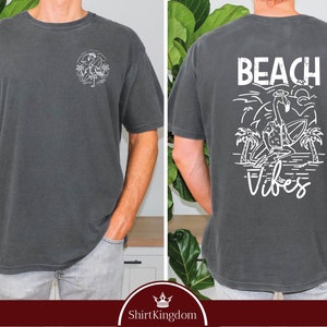 a man wearing a t - shirt that says beach vibes