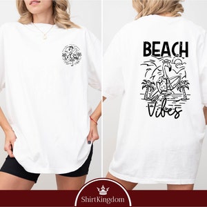 a woman wearing a white t - shirt with black writing on it