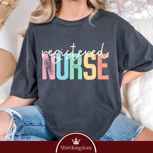 a woman sitting on a couch wearing a black shirt with the words, required nurse