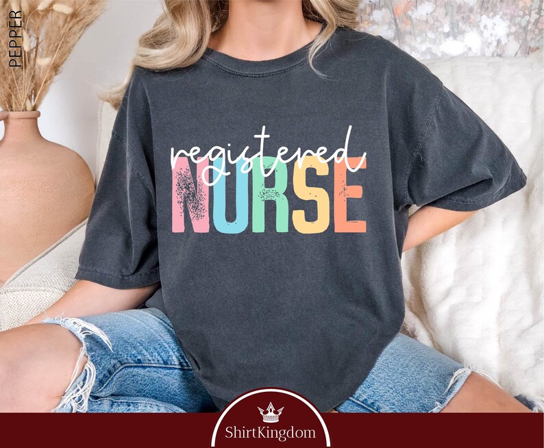 a woman sitting on a couch wearing a black shirt with the words, required nurse