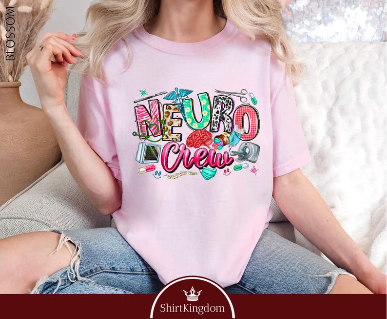 A woman wearing a pink t-shirt with the text "NEURO COUNCIL" printed on it, sitting on a couch.