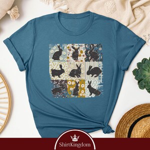 a blue t - shirt with a picture of cats on it