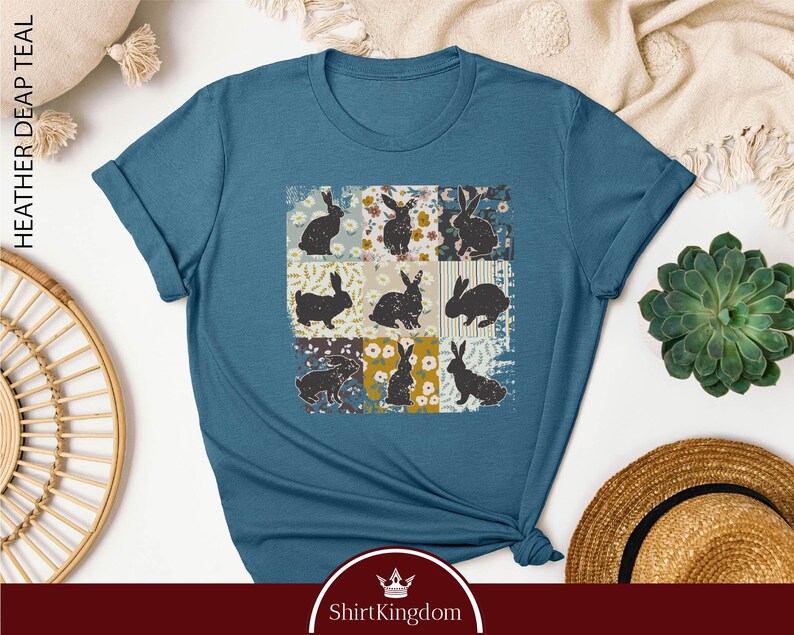 a blue t - shirt with a picture of cats on it
