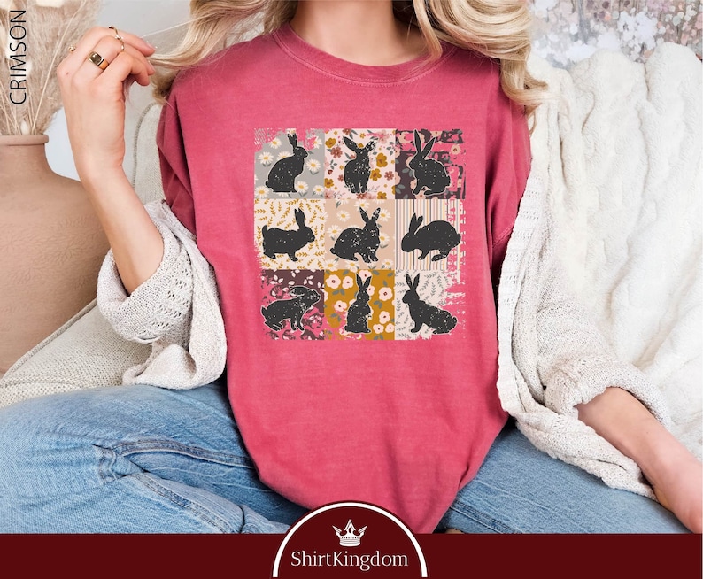 a woman wearing a pink shirt with black cats on it