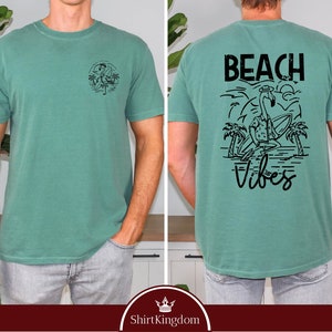 a man wearing a t - shirt that says beach vibes