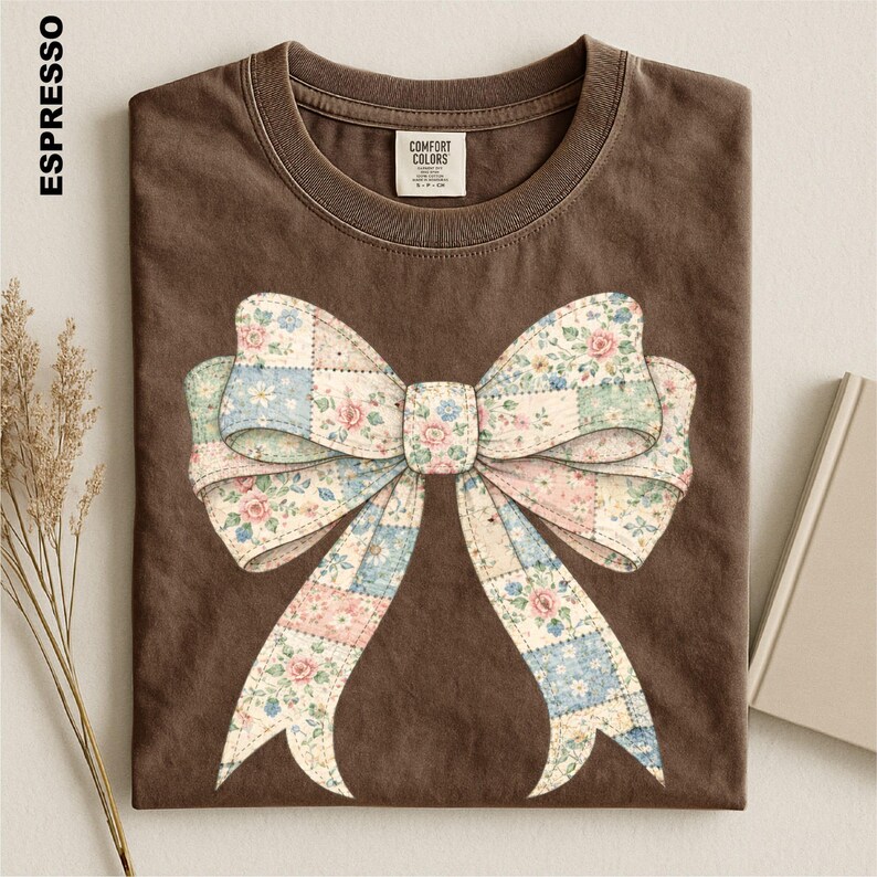 a brown t-shirt with a large floral bow design on it.
