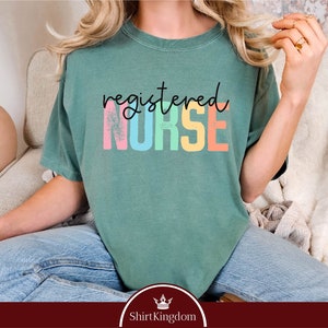 a woman sitting on a couch wearing a green shirt
