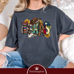 a woman sitting on a couch wearing a t - shirt that says texas