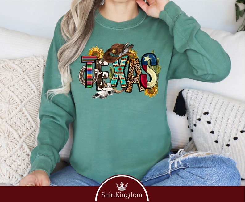 a woman sitting on a couch wearing a green sweatshirt