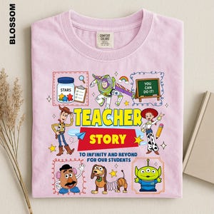 A pink t-shirt with a colorful and whimsical design featuring characters from the Toy Story movie, including Woody, Buzz Lightyear, and other beloved characters.
