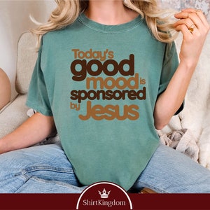 a woman wearing a t - shirt that says today's good mood is sponsored
