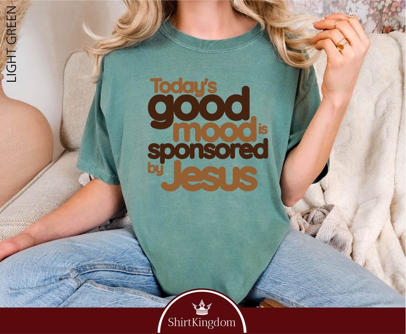 a woman wearing a t - shirt that says today's good mood is sponsored