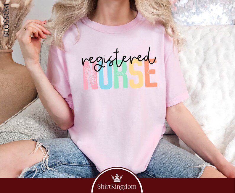 a woman sitting on a couch wearing a pink shirt
