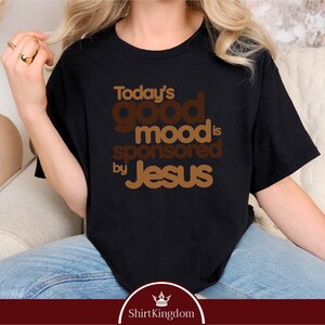 a woman sitting on a couch wearing a t - shirt that says today's