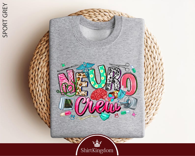A gray sweatshirt with a colorful graphic design featuring the word "Neuro Crew" surrounded by various medical and healthcare-related icons.