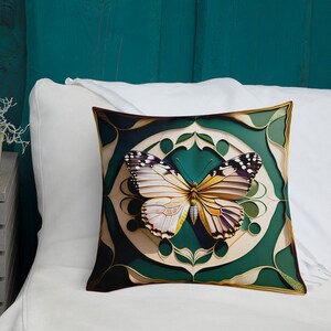 May include: A decorative pillow featuring a white and yellow butterfly with black markings, set against a green and gold background. The butterfly is centered in a circular design with intricate details.