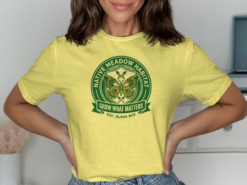 Yellow t-shirt with green Native Meadow Habitat logo featuring butterflies and text.