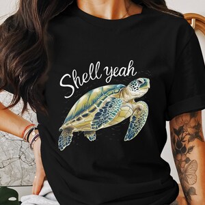 May include: Black t-shirt with a graphic of a sea turtle and the text "Shell yeah".