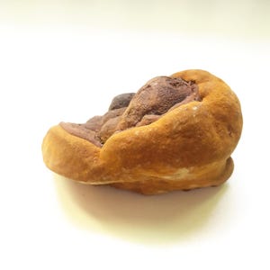 May include: A close-up of a brown and tan mushroom with a textured surface.
