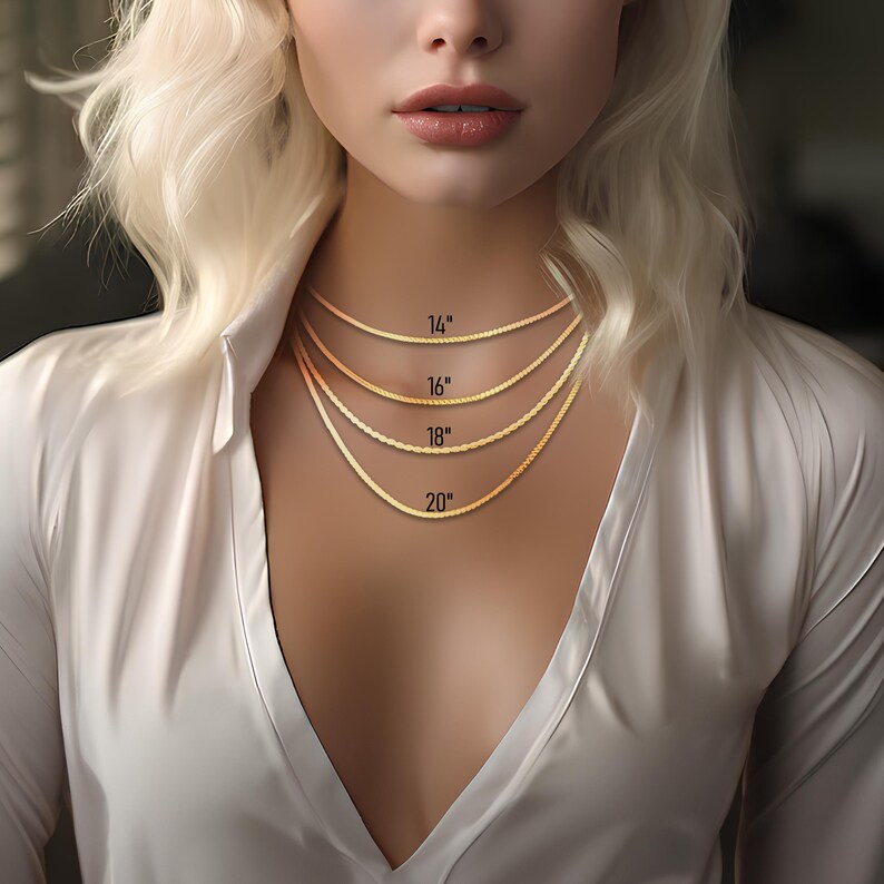 May include: A model wears a gold chain necklace in five different lengths: 14 inches, 16 inches, 18 inches, and 20 inches. The model is wearing a white shirt.