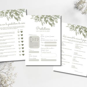 Pu&ograve; includere: Tre schede di gioco in carta bianca per baby shower con illustrazioni di foglie di eucalipto ad acquerello verde nella parte superiore. Le schede includono testo in francese, con sezioni per previsioni e giochi a quiz.