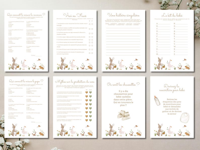May include: A set of eight cream-colored baby shower game cards. Each card features a different game with text in French, along with illustrations of bunnies, baskets, and flowers. The cards are arranged on a white surface.