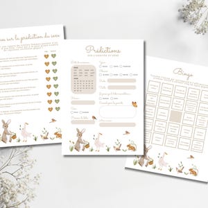 May include: Three white paper sheets with French text and watercolor illustrations. The sheets include a baby shower game, a bingo game, and a sheet for predictions. The illustrations include bunnies, birds, and flowers.