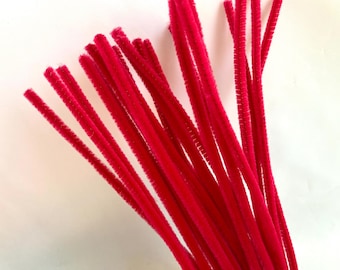 May include: A bunch of bright pink pipe cleaners. The pipe cleaners are bundled together and are ready for crafting.