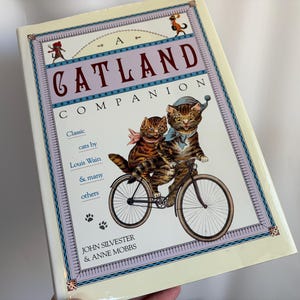 A CATLAND COMPANION John Silvester Anne Mobbs | Classic Cats by Louis Wain & Others |Vintage (c) 1991 Hardcover BOOK | 96 Pgs | 12” x 8-1/2”