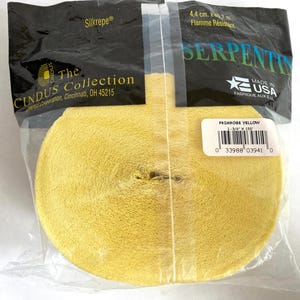 May include: A roll of primrose yellow crepe paper ribbon, 1-3/4" x 150', packaged in a clear plastic bag. The package includes the text "Silkrepe" and "The Cindus Collection, Cincinnati, OH 45215". The label reads "Primrose Yellow".