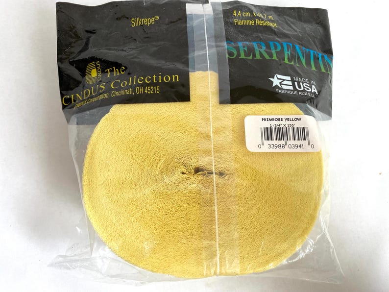 May include: A roll of primrose yellow crepe paper ribbon, 1-3/4" x 150', packaged in a clear plastic bag. The package includes the text "Silkrepe" and "The Cindus Collection, Cincinnati, OH 45215". The label reads "Primrose Yellow".