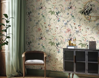 May include: A beige wallpaper with a floral pattern featuring pink, blue, and green flowers, leaves, and birds. The wallpaper is in a room with a chair and a cabinet.