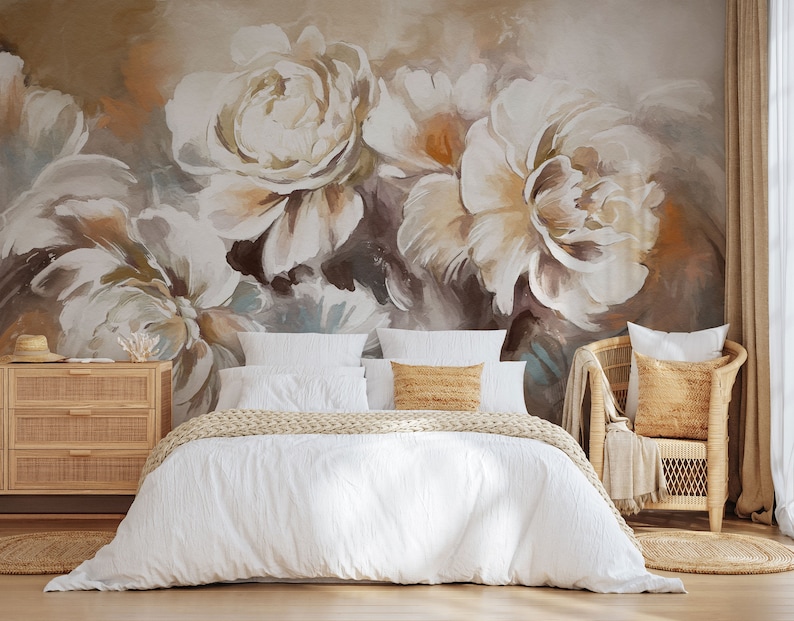 May include: A white bed with a white duvet cover and a tan knitted throw blanket. The bed is in front of a wall with a large abstract floral mural in shades of brown, white, and beige.