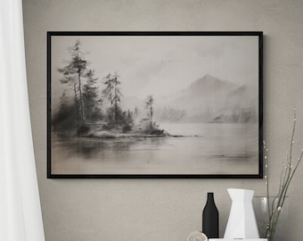 May include: A black and white framed print of a misty lake scene with trees and mountains in the background. The print is hanging on a light gray wall above a white cabinet with a chevron pattern.