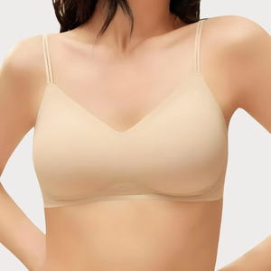 May include: A white ceramic mug with a black handle and the text "But First, Coffee" in a bold, black font. The mug is set against a blurred background, suggesting a cozy setting. The mug appears to be approximately 4 inches tall.