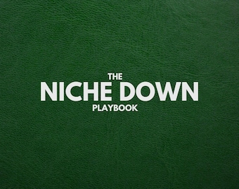 May include: A dark green textured surface with the white text "THE NICHE DOWN PLAYBOOK". The text is centered and in a bold, sans-serif font. The background has a subtle, leather-like appearance.
