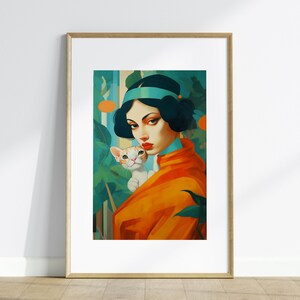 May include: A framed art print featuring a woman in an orange jacket with a white and orange cat. The artwork has a vintage style with a teal and green background. The woman has dark hair and a teal headband.