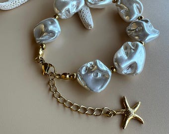 Pulseira com pingente de estrela-do-mar: pérolas de concha cor marfim, ajustável em aço inoxidável.