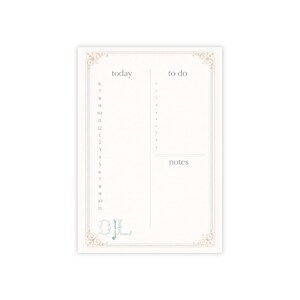 May include: A cream-coloured notepad with a decorative border and the words "today", "to do", and "notes". The notepad has a time-based schedule from 6 AM to 11 PM. The initials "OL" are at the bottom.