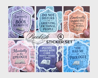May include: A set of six bookish stickers with various quotes and illustrations. The stickers feature phrases like "Currently in a Book Hangover" and "You Had Me at Prologue." Each sticker has a unique color scheme and design.