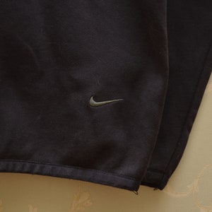 May include: Black Nike sweatshirt with a small Nike logo on the front.