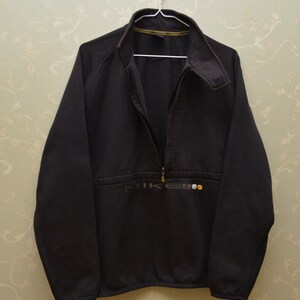 May include: A black Nike fleece jacket with a half-zip closure and a small Nike logo on the front.