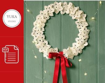 May include: A white crocheted wreath with a red ribbon bow, hanging on a green wooden door with white string lights.